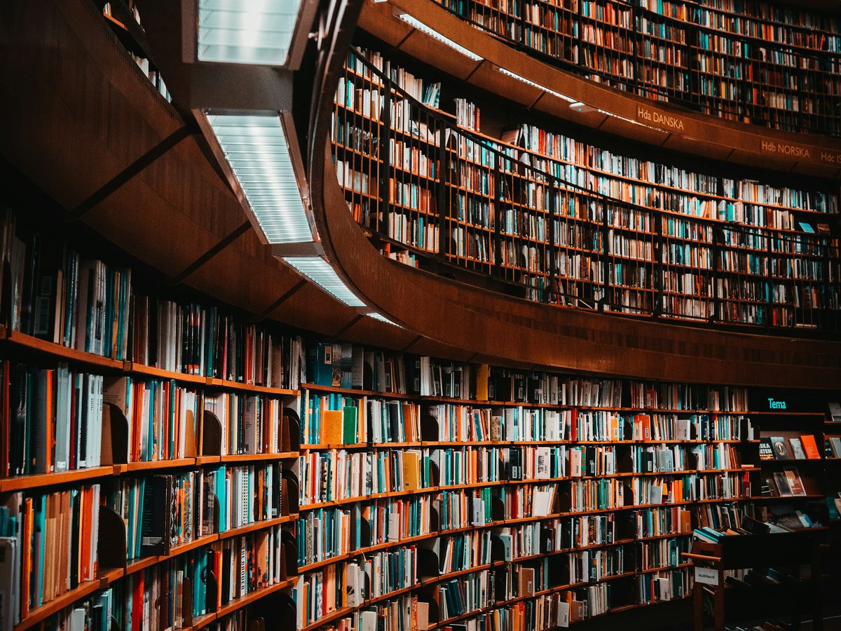 Curving tiers of bookshelves inside a modern research library.